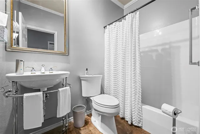 a bathroom with a sink toilet and shower