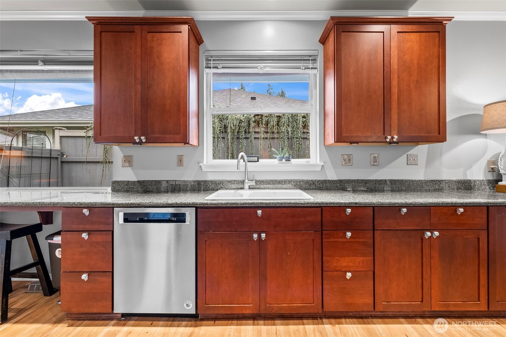 1113 Garden Circle Fircrest, WA 98466 - Photo 4 of 29 a kitchen with granite countertop a sink window and cabinets