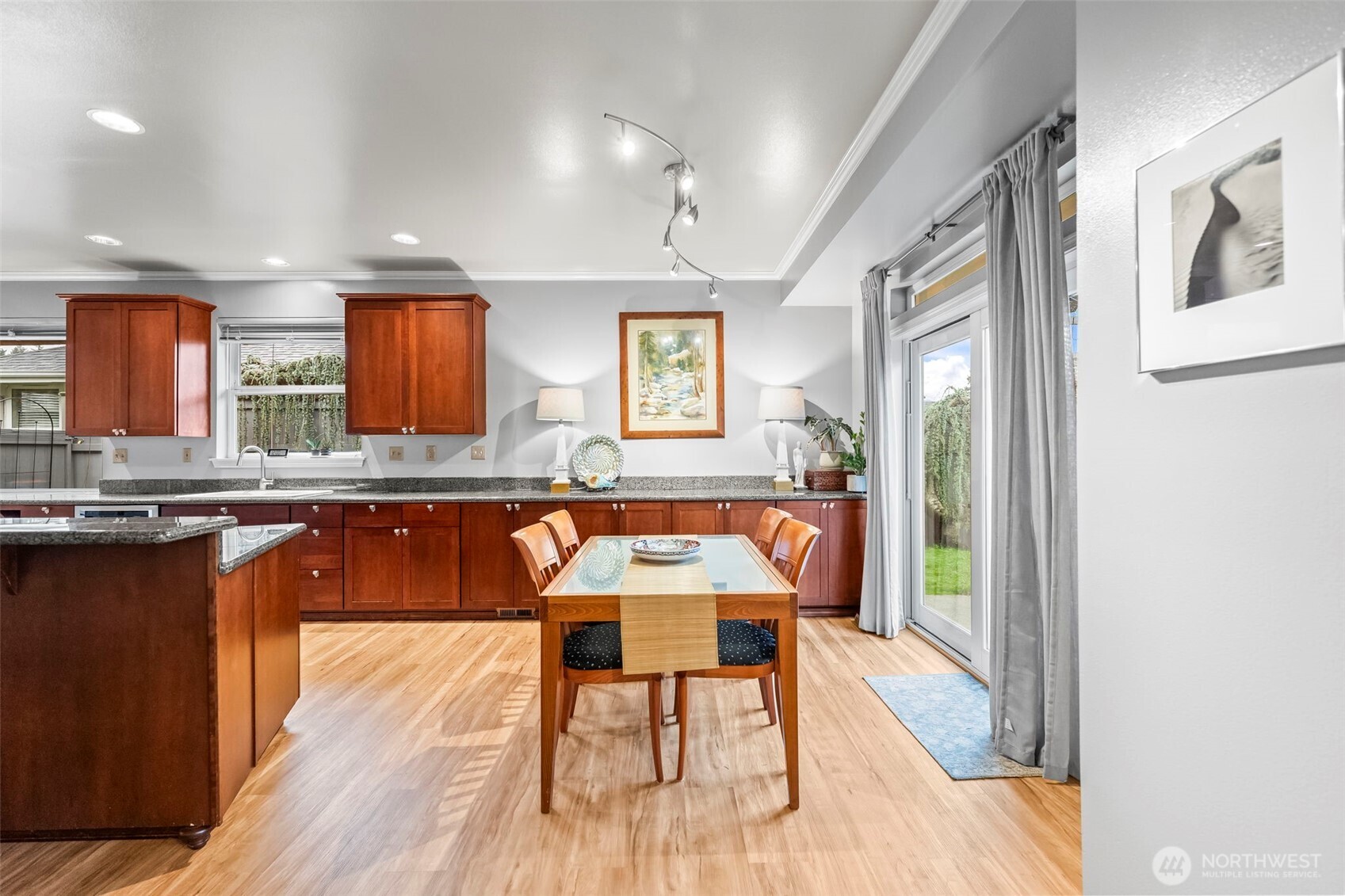 1113 Garden Circle Fircrest, WA 98466 - Photo 8 of 29 a dining room with granite countertop wooden floor and stainless steel appliances