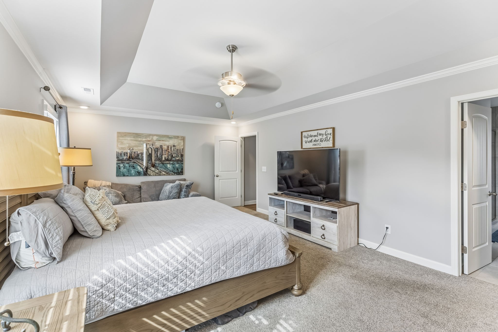 343 Wildcat Run Gallatin, TN 37066 - Photo 12 of 29 a bedroom with a large bed and a flat tv screen on a dresser