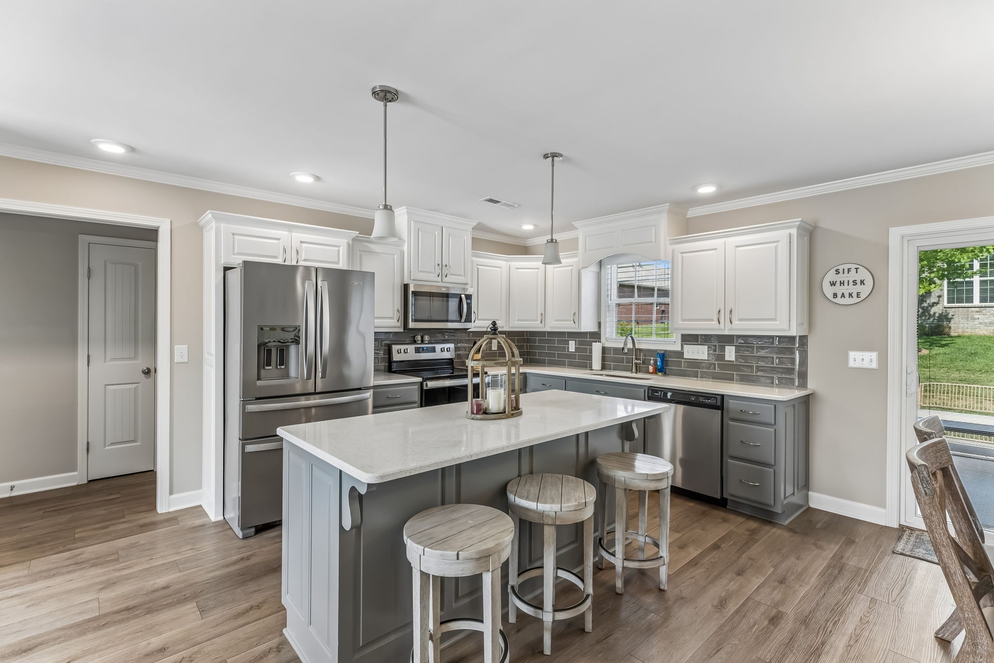 343 Wildcat Run Gallatin, TN 37066 - Photo 8 of 29 a kitchen with kitchen island granite countertop a center island stainless steel appliances cabinets and wooden floor