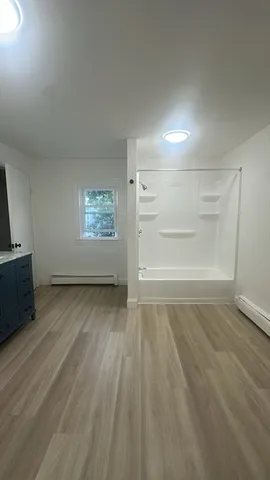 wooden floor in an empty room with a window