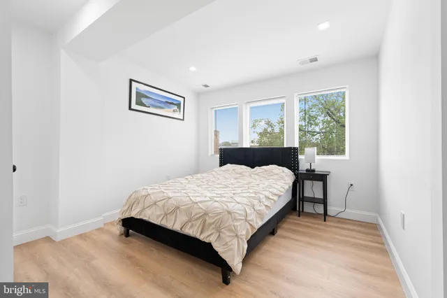 a bed sitting in a bedroom next to a window