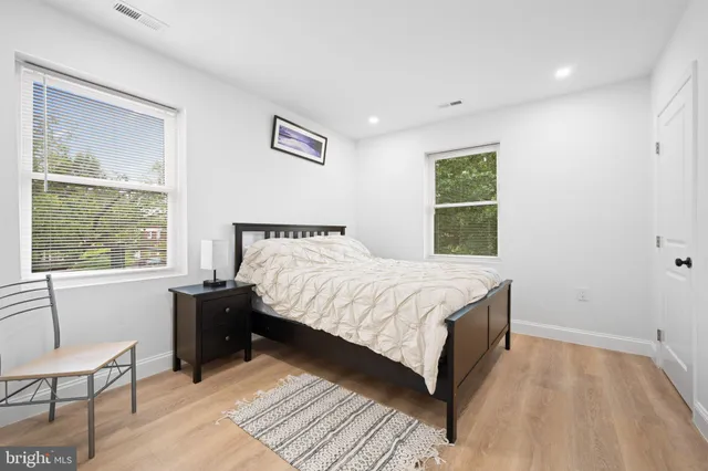 a bathroom with a bathtub sink vanity mirror and toilet