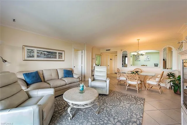 a living room with furniture a rug and a chandelier
