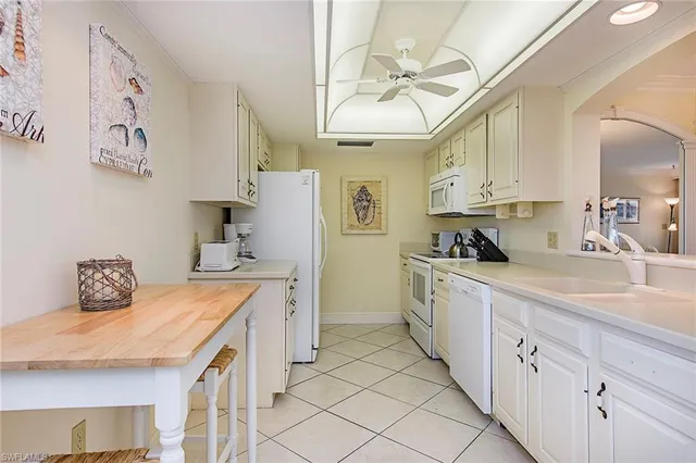 a kitchen with cabinets a sink and appliances