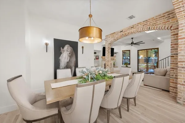 a dining room with furniture and wooden floor