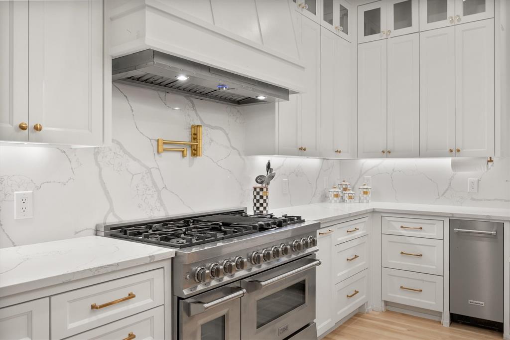 1911 Ozro Road Venus, TX 76084 - Photo 15 of 40 a kitchen with a stove and white cabinets