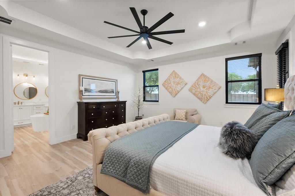 1911 Ozro Road Venus, TX 76084 - Photo 19 of 40 a bedroom with a large bed chandelier and a window