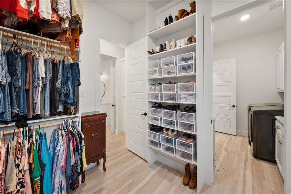 1911 Ozro Road Venus, TX 76084 - Photo 21 of 40 a view of walk in closet with clothes and shoes