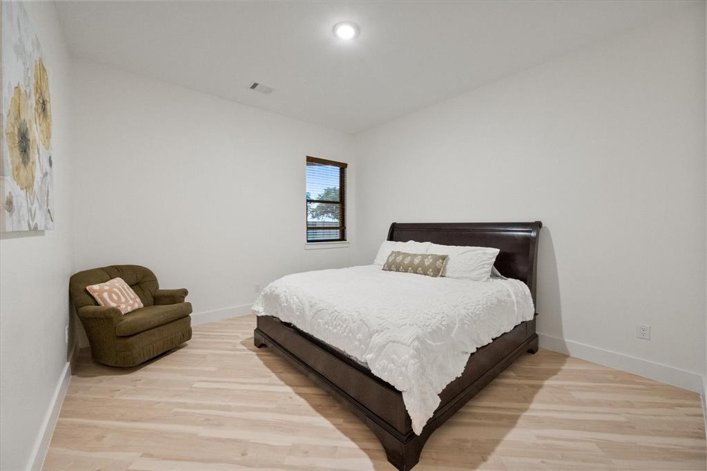 1911 Ozro Road Venus, TX 76084 - Photo 23 of 40 a bedroom with bed couch and window