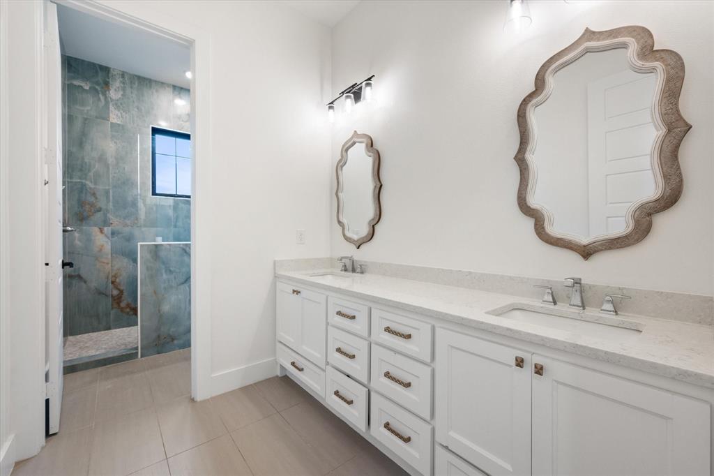 1911 Ozro Road Venus, TX 76084 - Photo 28 of 40 a bathroom with a double vanity sink mirror and shower