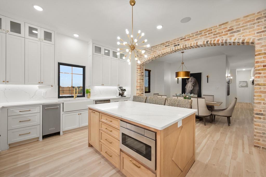 1911 Ozro Road Venus, TX 76084 - Photo 3 of 40 a kitchen that has a lot of white cabinets and couches
