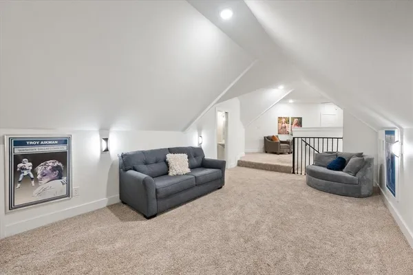 a living room with furniture and a ceiling fan