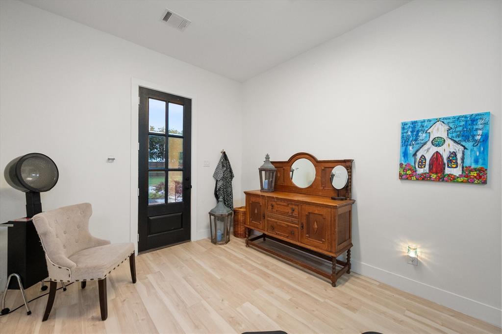 1911 Ozro Road Venus, TX 76084 - Photo 35 of 40 a bedroom with a bed and a table in it