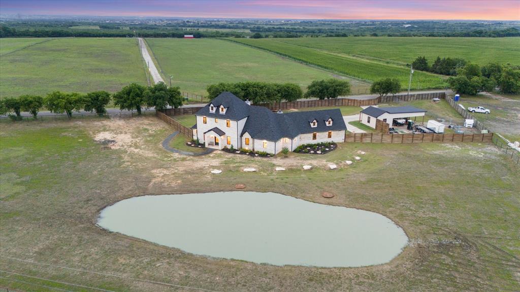 1911 Ozro Road Venus, TX 76084 - Photo 38 of 40 a view of a lake with a house in the background