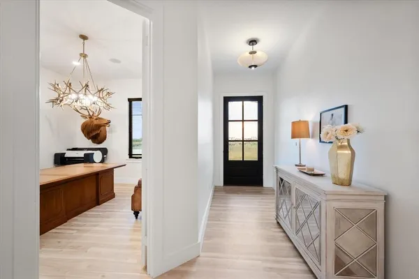 a hallway with fireplace and wooden floor