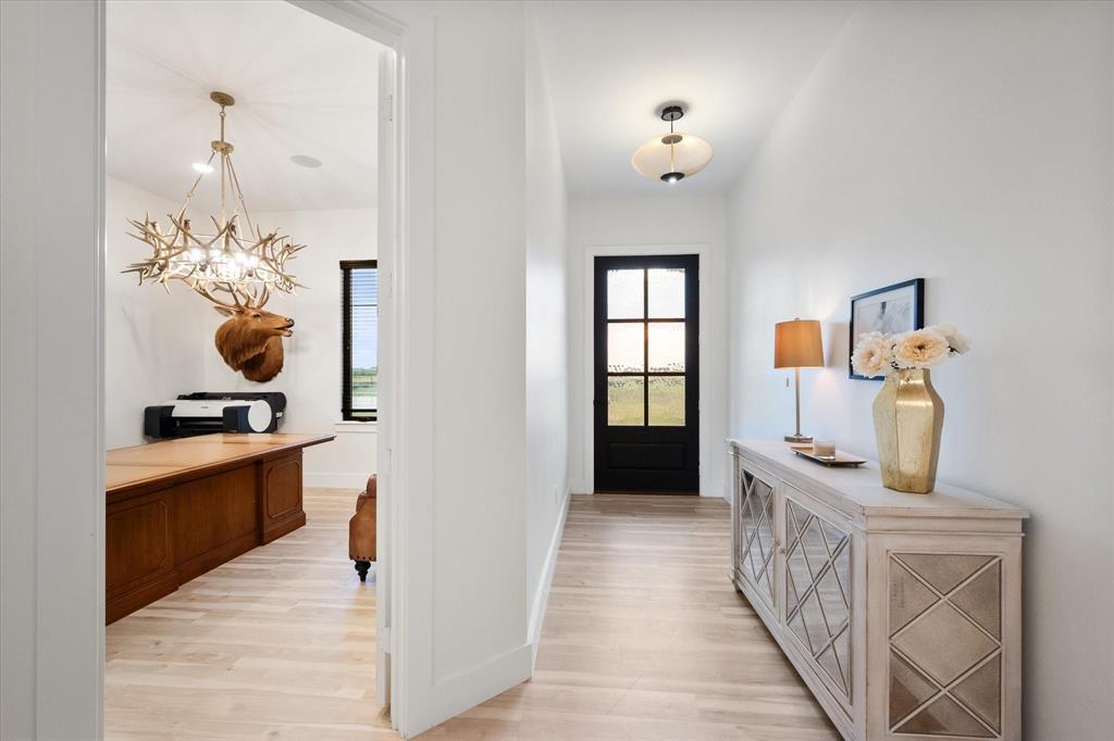 1911 Ozro Road Venus, TX 76084 - Photo 6 of 40 a hallway with fireplace and wooden floor