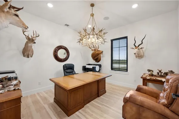 a living room with kitchen island furniture and a chandelier