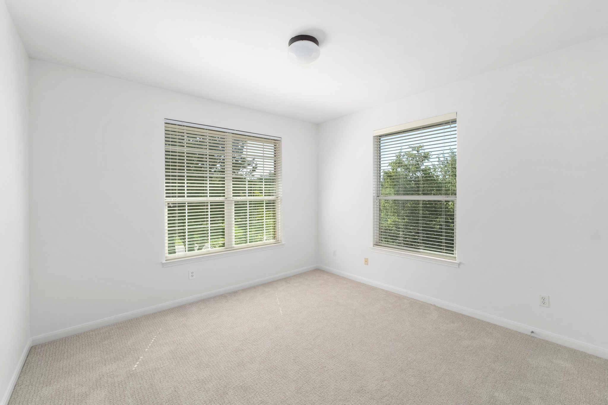 16200 Spillman Ranch Loop Austin, TX 78738 - Photo 28 of 36 Ample natural light illuminates this tranquil bedroom, offering a peaceful retreat.