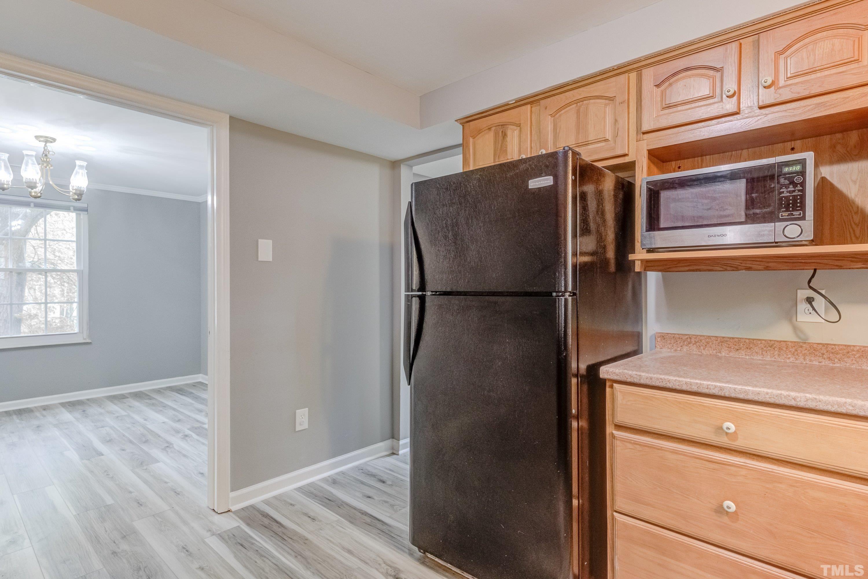 7921 Mourning Dove Road Raleigh, NC 27615 - Photo 9 of 52 a kitchen with stainless steel appliances granite countertop a refrigerator and a sink