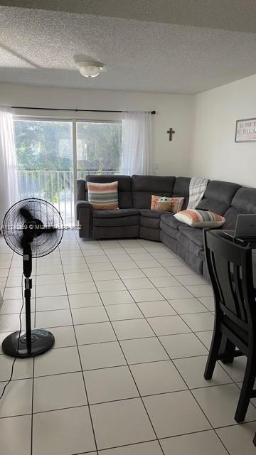 219 Riviera Circle, Unit 219 Weston, FL 33326 - Photo 11 of 22 a living room with furniture and a floor to ceiling window