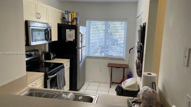 219 Riviera Circle, Unit 219 Weston, FL 33326 - Photo 12 of 22 a living room with furniture and a window