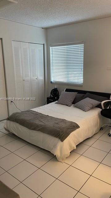 219 Riviera Circle, Unit 219 Weston, FL 33326 - Photo 15 of 22 a bedroom with a bed and window