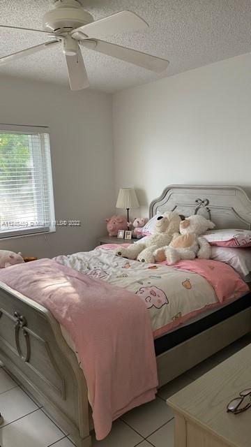 219 Riviera Circle, Unit 219 Weston, FL 33326 - Photo 18 of 22 a bedroom with a bed and a window