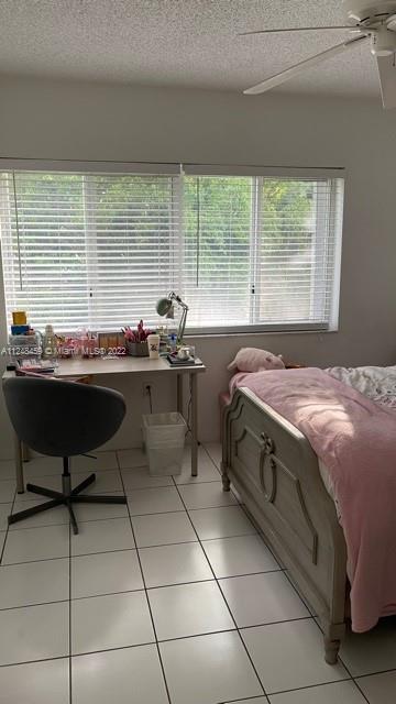 219 Riviera Circle, Unit 219 Weston, FL 33326 - Photo 19 of 22 a bed sitting in a room next to a window