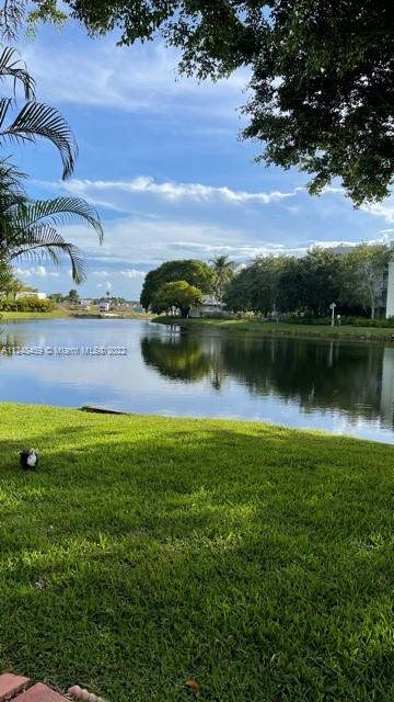 219 Riviera Circle, Unit 219 Weston, FL 33326 - Photo 2 of 22 a view of a water pond with green space