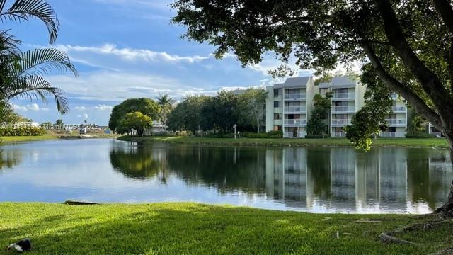 219 Riviera Circle, Unit 219 Weston, FL 33326 - Photo 3 of 22 a view of a lake with a building in the background