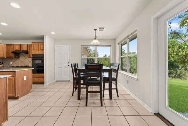 a dining room with furniture and window