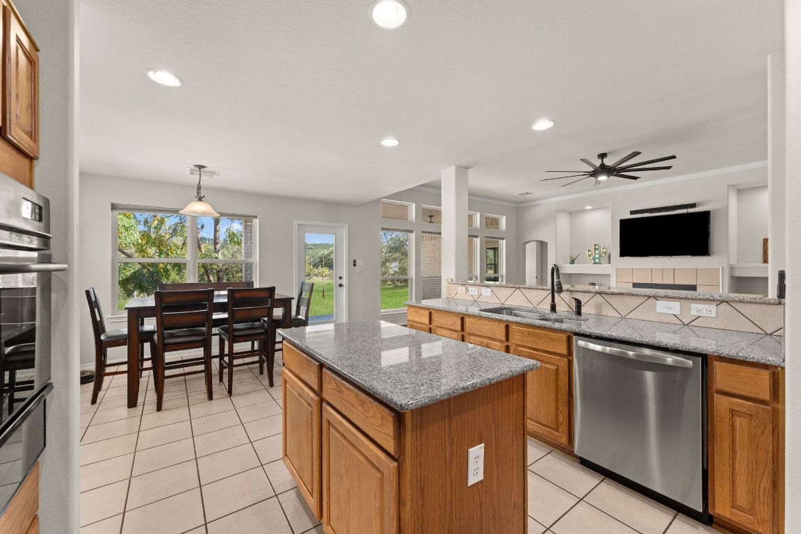 2201 Improver Road Spicewood, TX 78669 - Photo 13 of 26 a kitchen with a stove a sink and a refrigerator