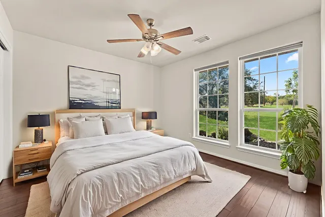 a bedroom with a large bed and a large window