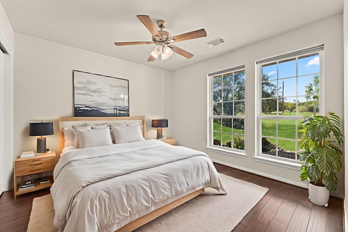 2201 Improver Road Spicewood, TX 78669 - Photo 17 of 26 a bedroom with a large bed and a large window