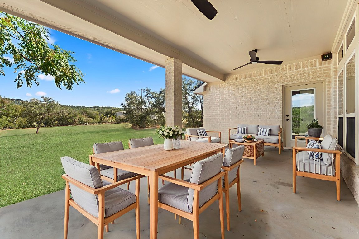 2201 Improver Road Spicewood, TX 78669 - Photo 18 of 26 a view of a patio with a table and chairs