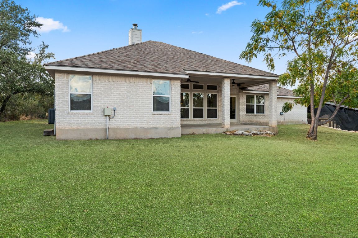 2201 Improver Road Spicewood, TX 78669 - Photo 19 of 26 a front view of house with yard and green space