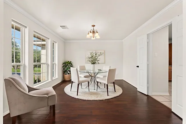 a dining room with furniture a window and wooden floor