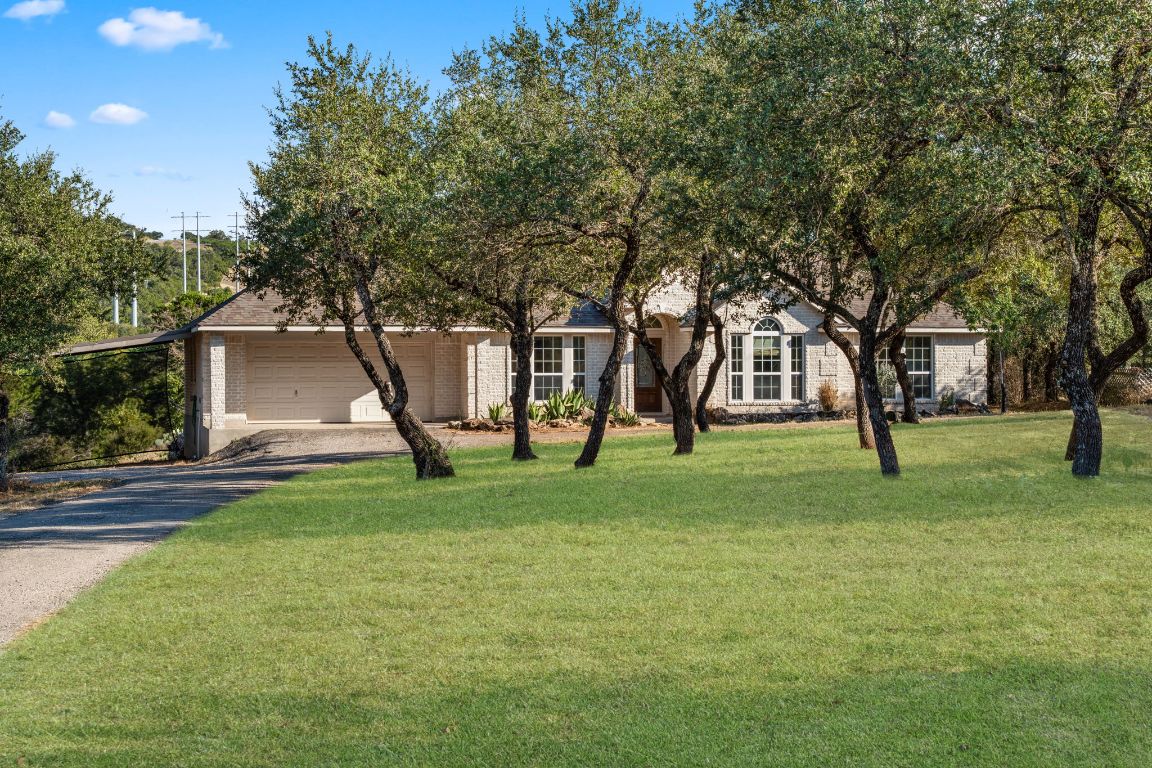 2201 Improver Road Spicewood, TX 78669 - Photo 7 of 26 a view of a house with a yard and tree s