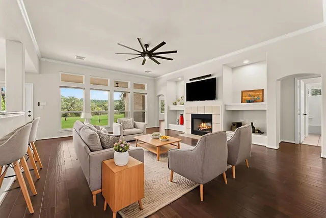 a living room with fireplace furniture and a flat screen tv