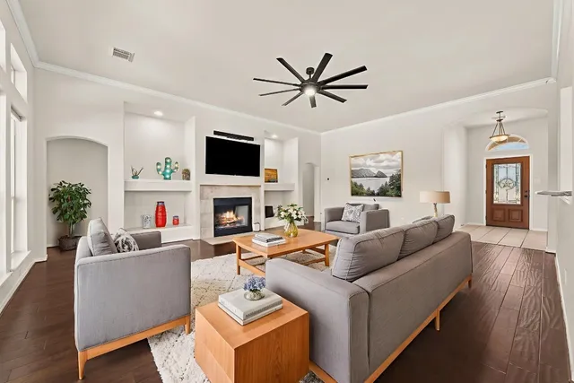 a living room with furniture a fireplace and a flat screen tv