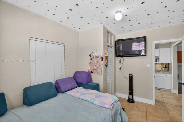 a bedroom with a bed and a television