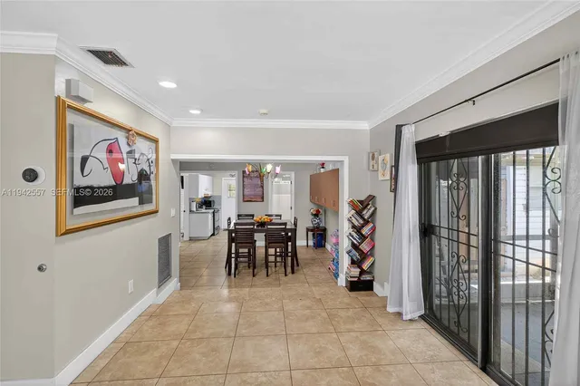 a view of a dining room with furniture and a potted plant