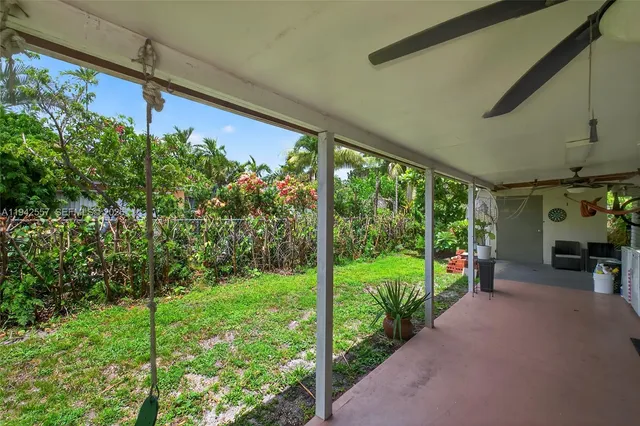 a view of a porch with furniture and garden
