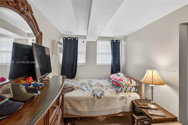 a front view of a house with a yard and potted plants