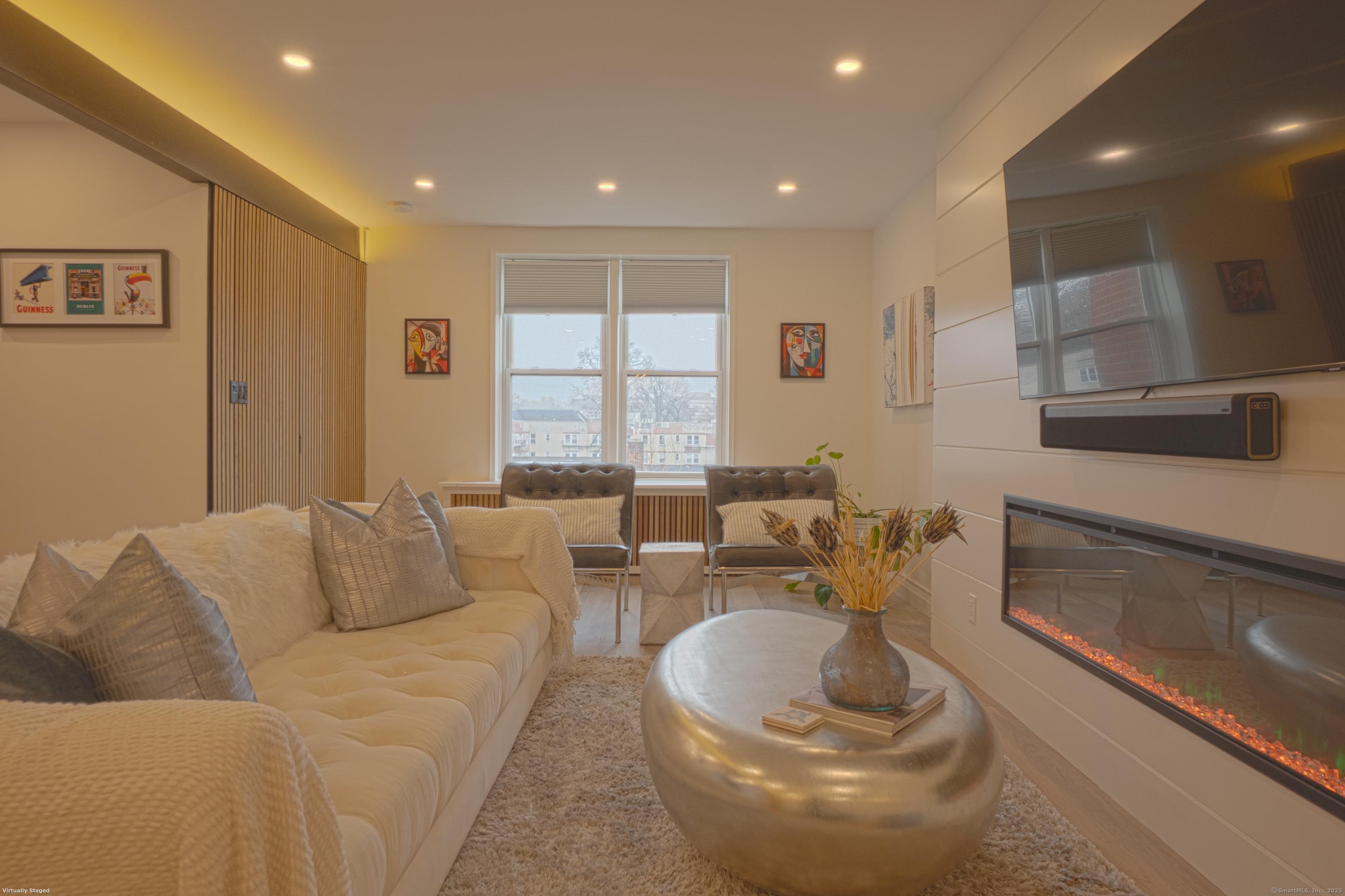 7 4th Street, Unit 4F Stamford, CT 06905 - Photo 4 of 19 Spacious living room with recessed lighting and electric fireplace.