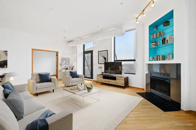 a living room with furniture flat screen tv and a fireplace