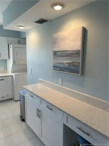 a room with a sink cabinets and utility room