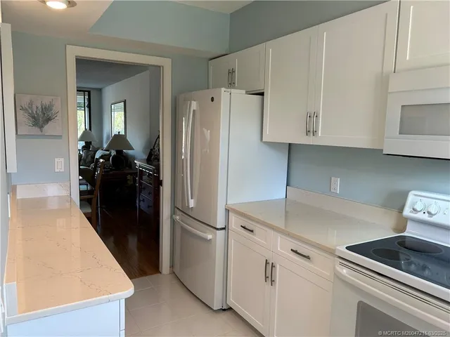 a kitchen with a refrigerator and cabinets